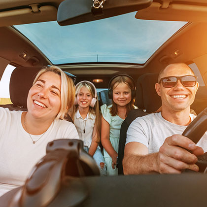 Young family driving in new car